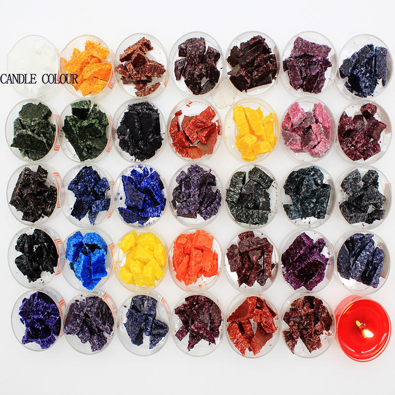 Rows of small dishes holding coloured candle wax flakes in many shades